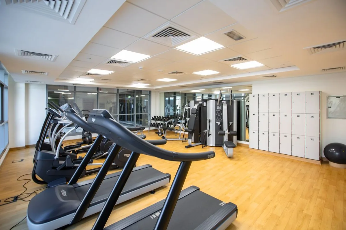 Clean gym floor with equipment ready for members